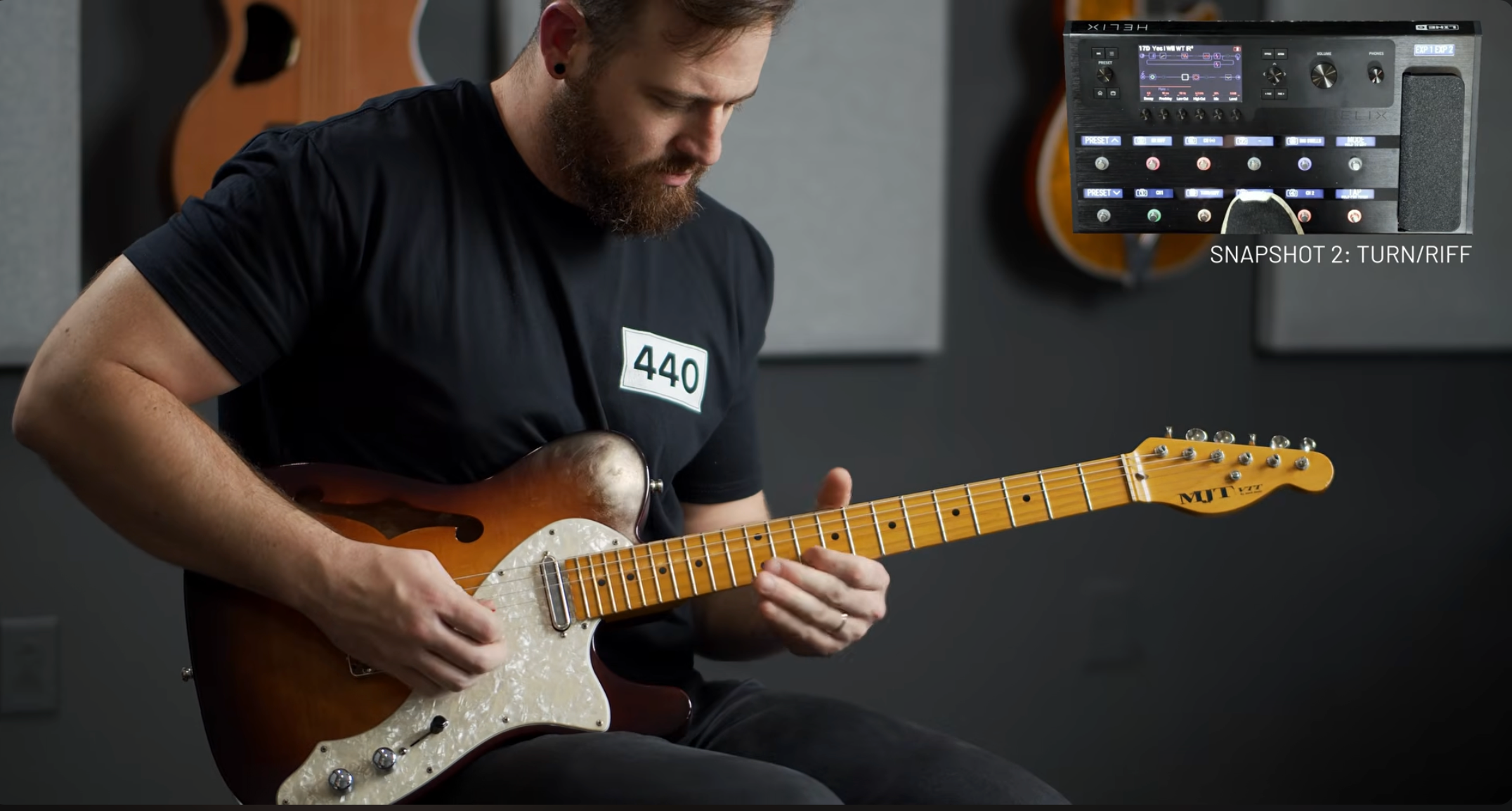 Guitar player playing a telecaster style guitar with a maple neck in a studio context